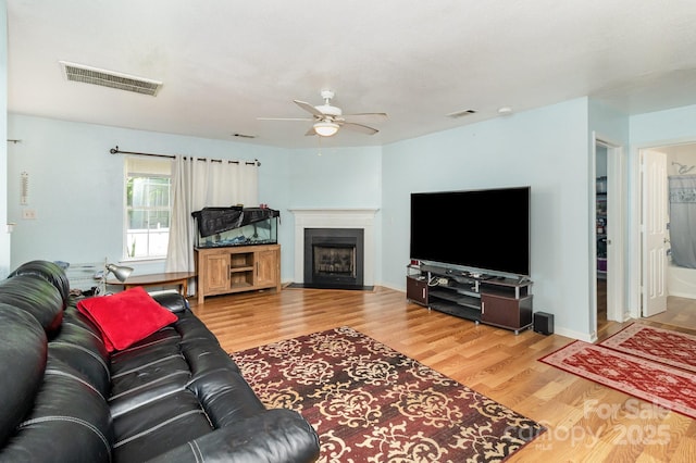 10816 Pointer Ridge Dr, Charlotte, NC 28214 - living room featuring a ceiling fan, wood finished floors, and a fireplace