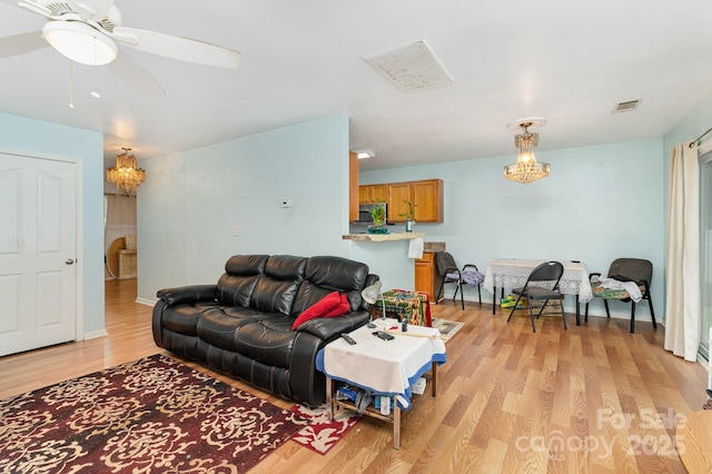 10816 Pointer Ridge Dr, Charlotte, NC 28214 - living room featuring light wood-style flooring, a chandelier, and ceiling fan