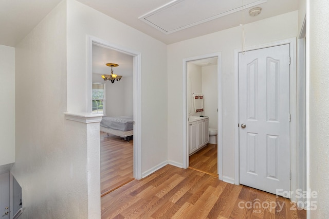10816 Pointer Ridge Dr, Charlotte, NC 28214 - hallway featuring attic access, light wood-type flooring, and baseboards