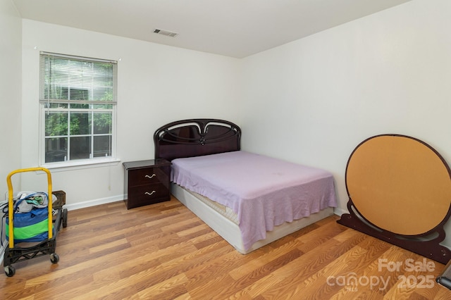 10816 Pointer Ridge Dr, Charlotte, NC 28214 - bedroom featuring light wood-style flooring and baseboards
