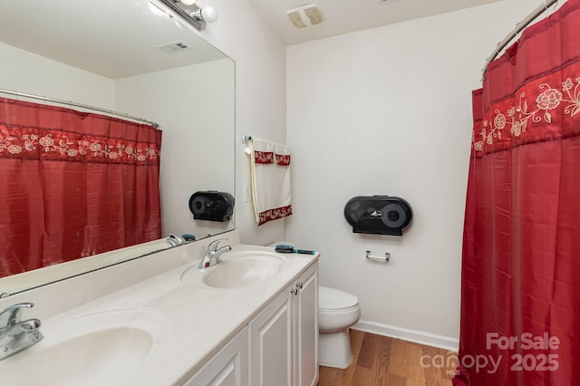 10816 Pointer Ridge Dr, Charlotte, NC 28214 - bathroom with toilet, wood finished floors, double vanity, baseboards, and a shower with curtain
