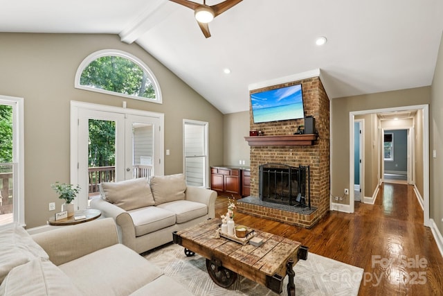 10311 Windtree Ln, Charlotte, NC 28215 - living room featuring a ceiling fan, wood finished floors, a brick fireplace, beamed ceiling, and baseboards
