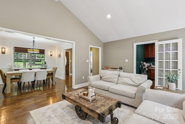 10311 Windtree Ln, Charlotte, NC 28215 - living room featuring wood finished floors, high vaulted ceiling, baseboards, and recessed lighting