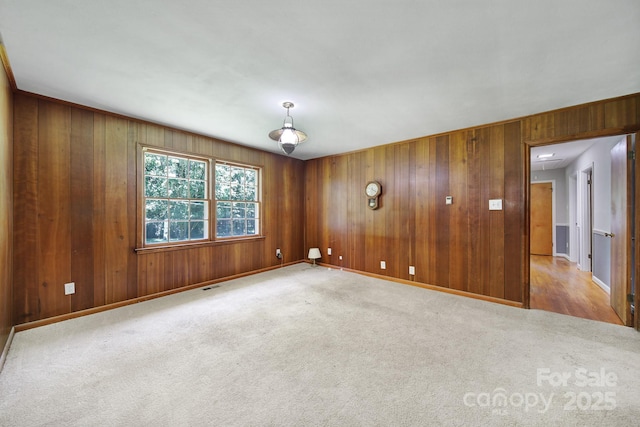 967 Hilldale Dr, Lancaster, SC 29720 - spare room featuring light colored carpet, wood walls, and baseboards