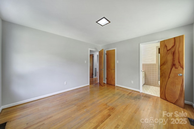 967 Hilldale Dr, Lancaster, SC 29720 - unfurnished bedroom featuring light wood-type flooring, baseboards, and ensuite bath
