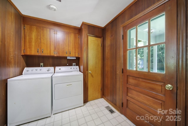 967 Hilldale Dr, Lancaster, SC 29720 - laundry room with cabinet space, washer and dryer, wooden walls, and light tile patterned floors