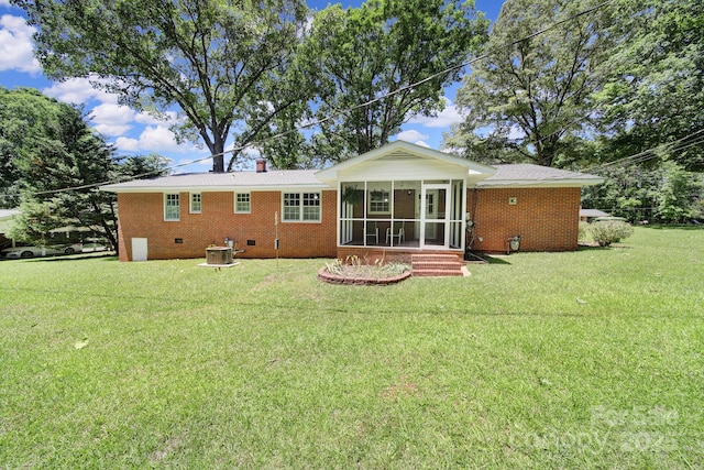 967 Hilldale Dr, Lancaster, SC 29720 - rear view of house with a sunroom, a lawn, brick siding, central AC, and a chimney