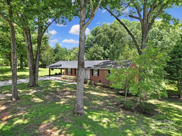 967 Hilldale Dr, Lancaster, SC 29720 - ranch-style house featuring concrete driveway, a carport, a front yard, and a chimney