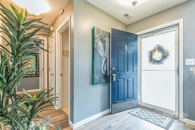 60 Southchase Dr, Fletcher, NC 28732 - foyer entrance featuring a textured ceiling, light wood-style floors, and baseboards