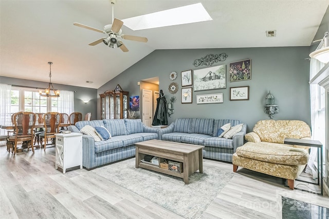 60 Southchase Dr, Fletcher, NC 28732 - living room featuring ceiling fan, light wood-style floors, vaulted ceiling, a chandelier, and a skylight