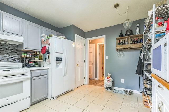 60 Southchase Dr, Fletcher, NC 28732 - kitchen with white appliances, under cabinet range hood, light countertops, gray cabinetry, and tasteful backsplash