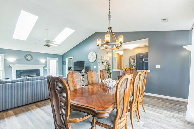 60 Southchase Dr, Fletcher, NC 28732 - dining area with a skylight, lofted ceiling, light wood-type flooring, a chandelier, and a high end fireplace