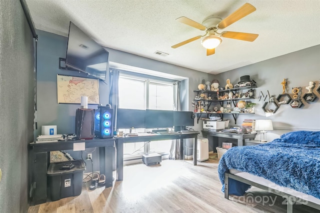 60 Southchase Dr, Fletcher, NC 28732 - bedroom featuring wood finished floors, an office area, a textured ceiling, and a ceiling fan