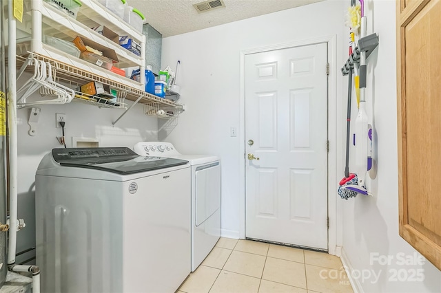60 Southchase Dr, Fletcher, NC 28732 - washroom featuring washing machine and clothes dryer, light tile patterned floors, a textured ceiling, and baseboards