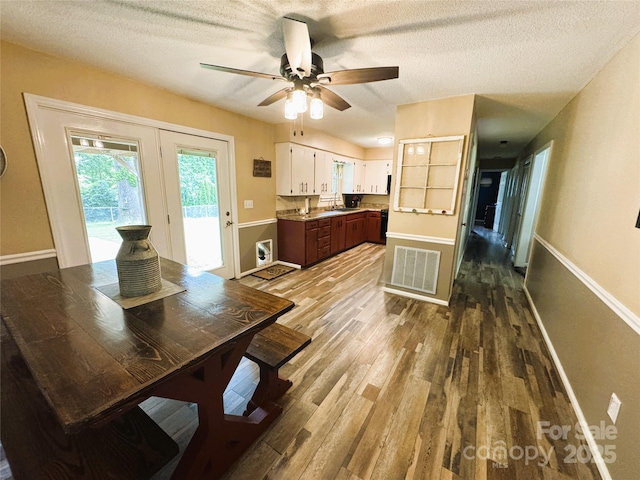 136 Christopher Rd, Marion, NC 28752 - dining space with wood finished floors, ceiling fan, a textured ceiling, and french doors