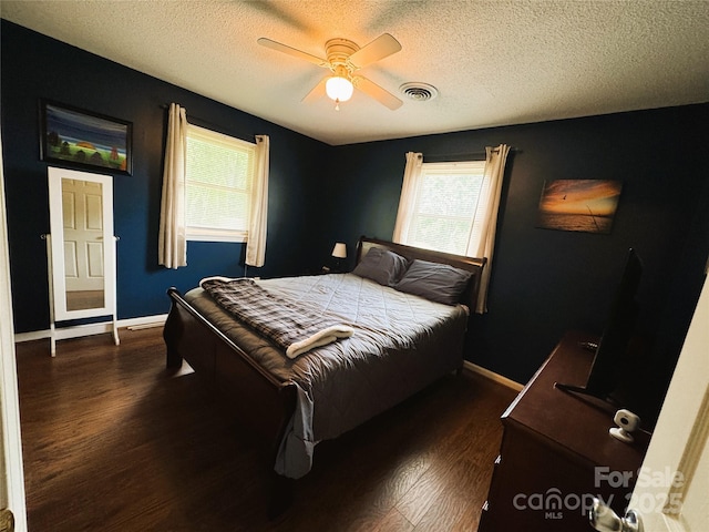 136 Christopher Rd, Marion, NC 28752 - bedroom featuring dark wood-style flooring, multiple windows, a textured ceiling, and ceiling fan