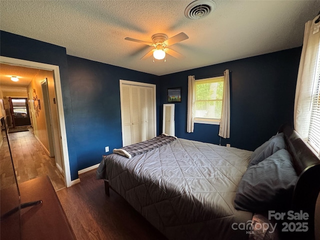 136 Christopher Rd, Marion, NC 28752 - bedroom featuring wood finished floors, a closet, a textured ceiling, and a ceiling fan