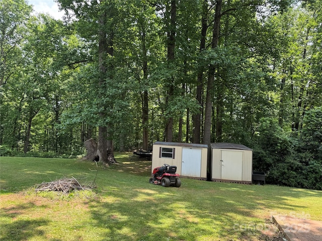 136 Christopher Rd, Marion, NC 28752 - view of green lawn featuring a shed and a wooded view