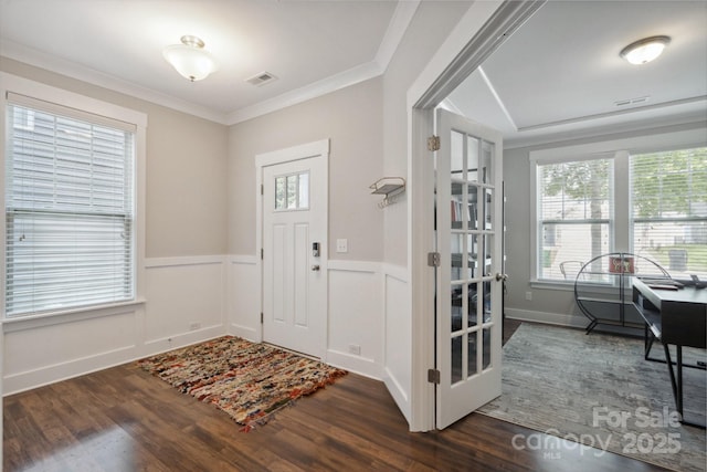 10012 Michael Crossing Dr, Charlotte, NC 28213 - entrance foyer featuring dark wood-style flooring, a wainscoted wall, and crown molding