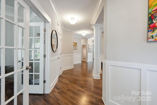 10012 Michael Crossing Dr, Charlotte, NC 28213 - hallway featuring decorative columns, crown molding, dark wood-type flooring, wainscoting, and french doors