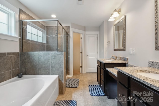 10012 Michael Crossing Dr, Charlotte, NC 28213 - full bath with a shower stall, two vanities, a garden tub, and tile patterned floors