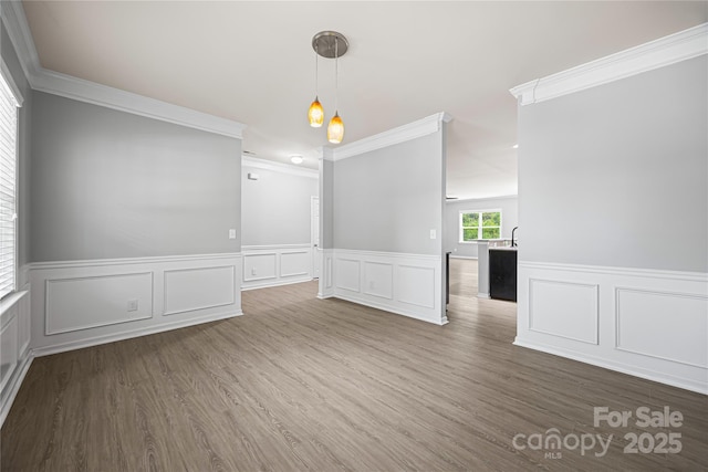 8400 Empress Ct, Charlotte, NC 28227 - empty room with a decorative wall, wainscoting, ornamental molding, and wood finished floors