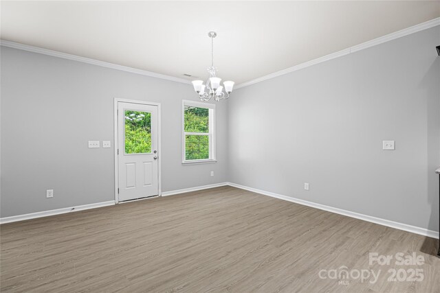 8400 Empress Ct, Charlotte, NC 28227 - spare room featuring a chandelier, wood finished floors, ornamental molding, and baseboards