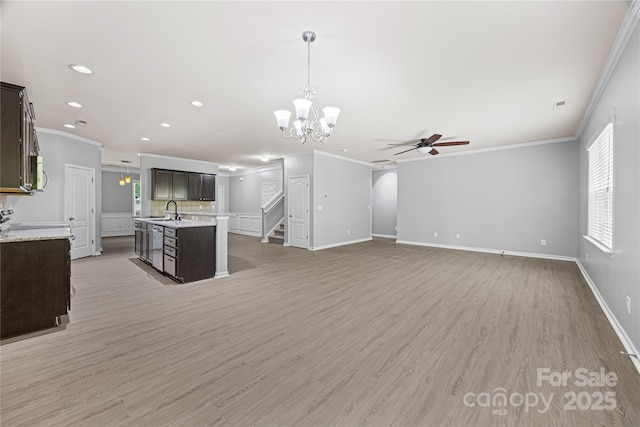 8400 Empress Ct, Charlotte, NC 28227 - kitchen with ornamental molding, ceiling fan, a chandelier, dark brown cabinets, and a sink
