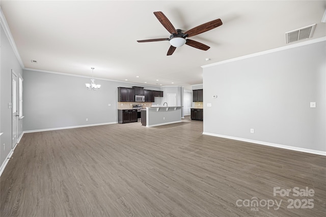 8400 Empress Ct, Charlotte, NC 28227 - unfurnished living room with a chandelier, ornamental molding, ceiling fan, baseboards, and recessed lighting