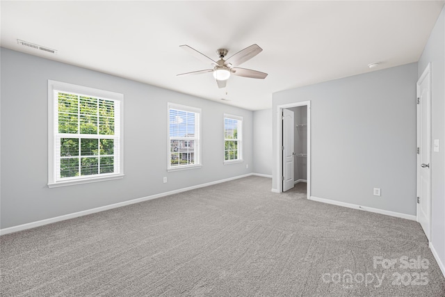 8400 Empress Ct, Charlotte, NC 28227 - unfurnished bedroom with baseboards, carpet floors, a spacious closet, a ceiling fan, and a closet