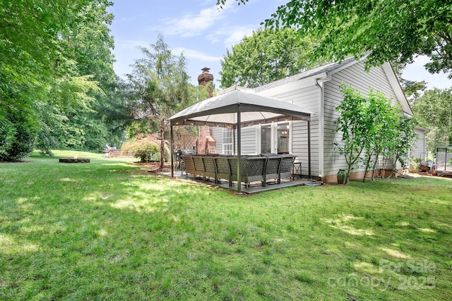 5400 Groveton Ct, Charlotte, NC 28269 - view of grassy yard featuring a gazebo, an outdoor living space with a fire pit, and a patio area