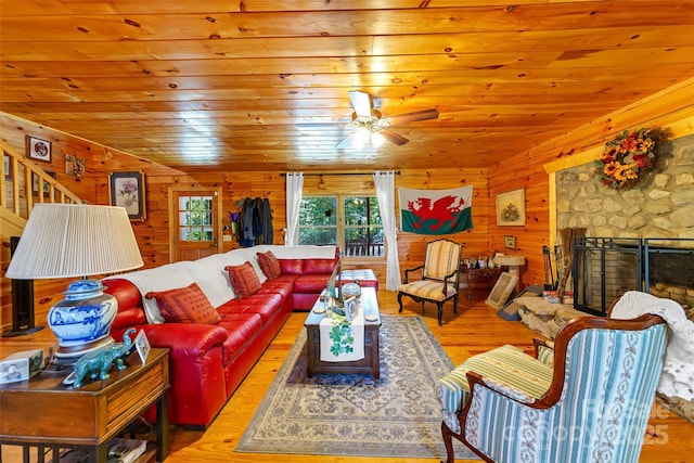 252 Idylwild Ln, Black Mountain, NC 28711 - living room with wood finished floors, wood walls, wood ceiling, a stone fireplace, and ceiling fan
