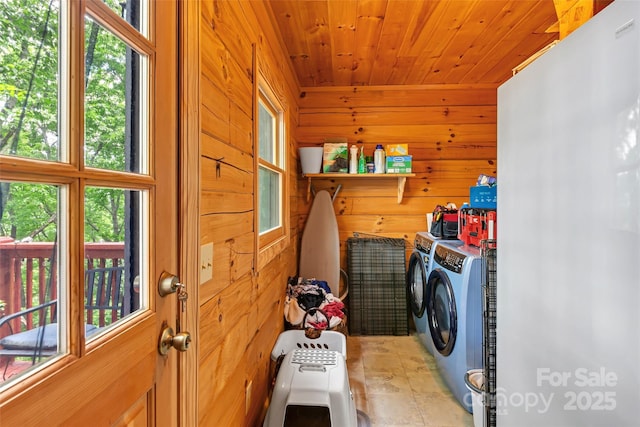 252 Idylwild Ln, Black Mountain, NC 28711 - laundry area featuring washing machine and dryer, wood walls, wood ceiling, and plenty of natural light