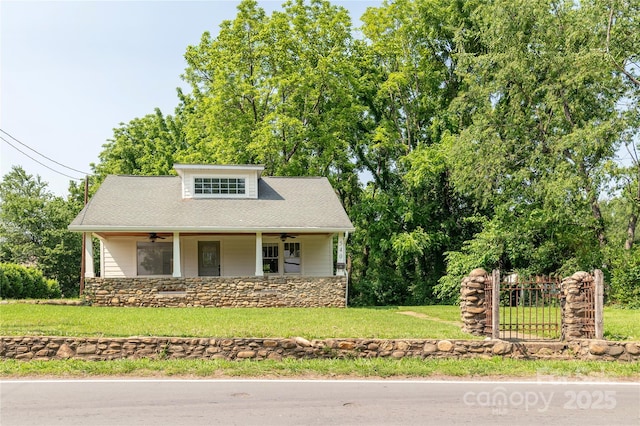 540 Fairview Rd, Asheville, NC 28803 - view of front of house with ceiling fan, a front lawn, and stone siding