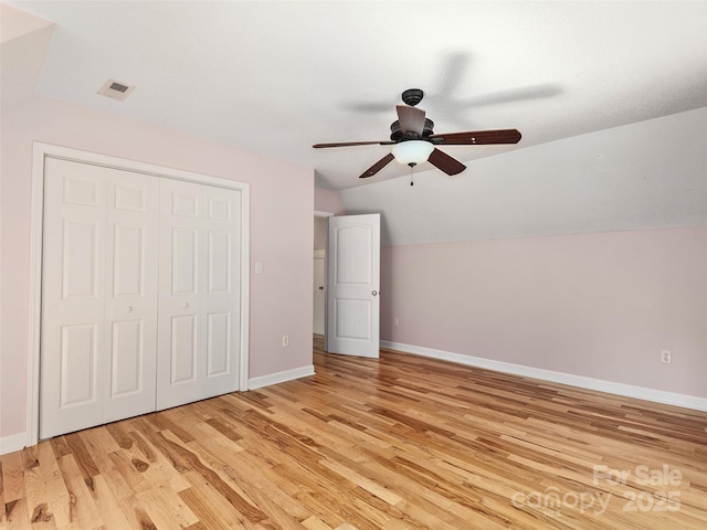 31 Rory Phillips Vw, Candler, NC 28715 - unfurnished bedroom with vaulted ceiling, light wood-style floors, baseboards, a closet, and ceiling fan
