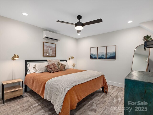 31 Rory Phillips Vw, Candler, NC 28715 - bedroom with an AC wall unit, wood finished floors, recessed lighting, a ceiling fan, and baseboards
