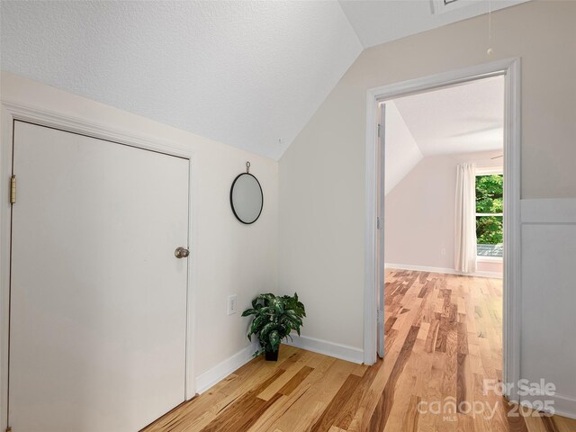 31 Rory Phillips Vw, Candler, NC 28715 - hallway featuring vaulted ceiling, light wood-style flooring, attic access, and baseboards