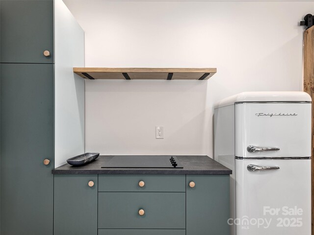 31 Rory Phillips Vw, Candler, NC 28715 - detailed view of freestanding refrigerator and black electric stovetop