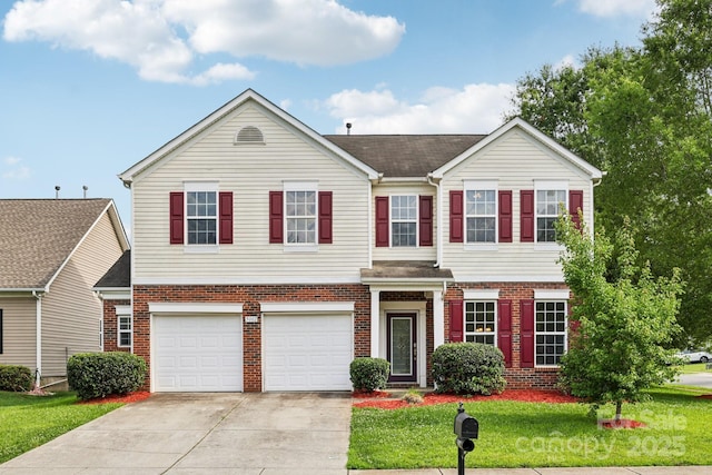 5002 Abode Lily Ln, Charlotte, NC 28227 - view of front of home with concrete driveway, a garage, brick siding, and a front lawn