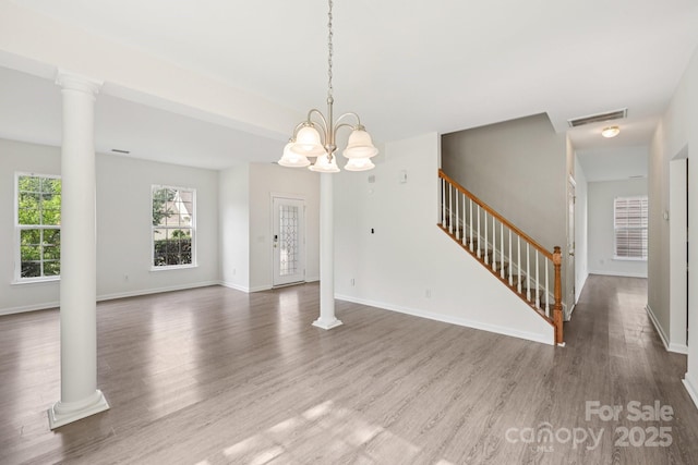 5002 Abode Lily Ln, Charlotte, NC 28227 - unfurnished living room with wood finished floors, stairs, and ornate columns