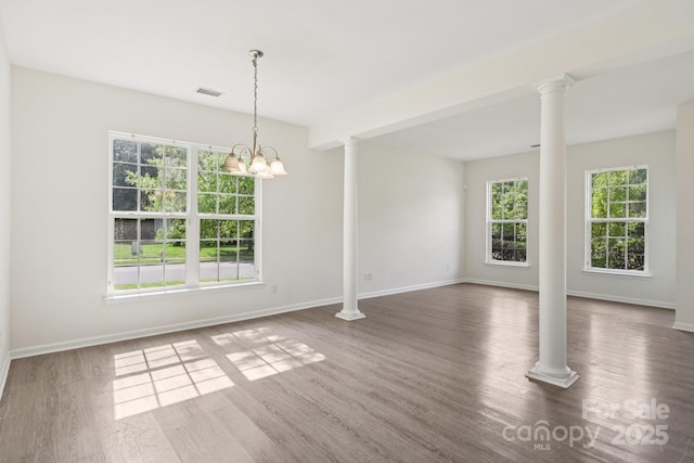 5002 Abode Lily Ln, Charlotte, NC 28227 - unfurnished room with ornate columns, wood finished floors, and a chandelier