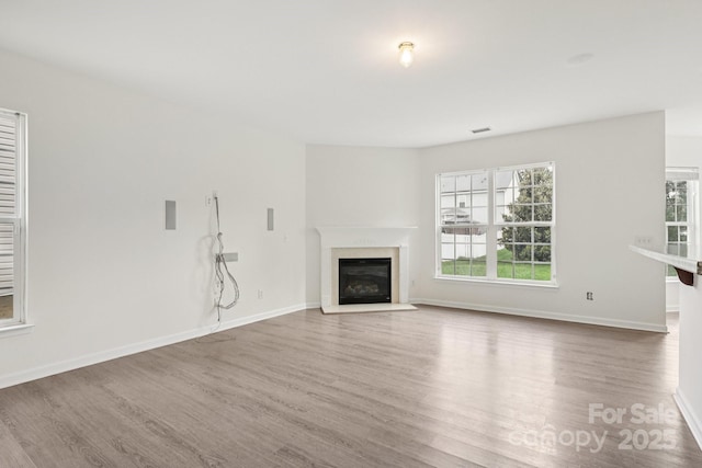5002 Abode Lily Ln, Charlotte, NC 28227 - unfurnished living room featuring wood finished floors and a high end fireplace