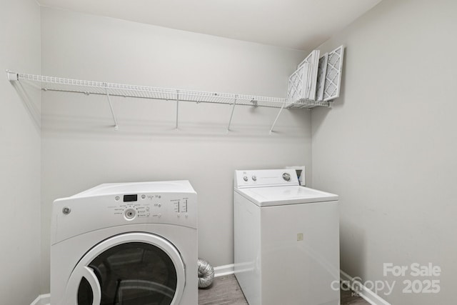 5002 Abode Lily Ln, Charlotte, NC 28227 - laundry room featuring washer and clothes dryer and wood finished floors