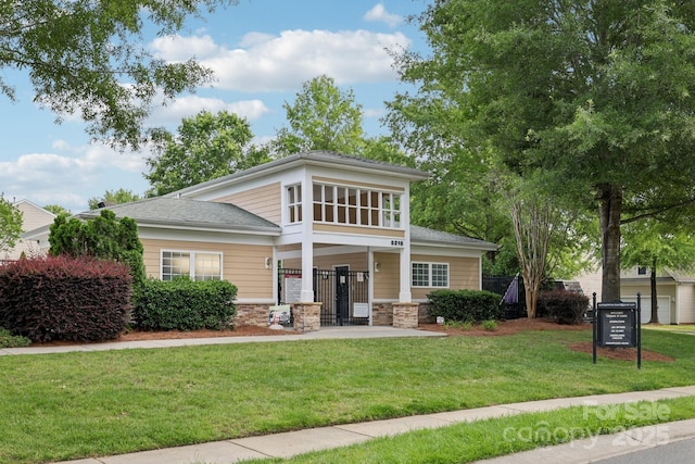 5002 Abode Lily Ln, Charlotte, NC 28227 - view of front of property with stone siding, a front lawn, and a shingled roof