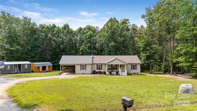 251 Vera Ln, Columbus, NC 28722 - view of front of home featuring a porch, driveway, a front lawn, an attached carport, and crawl space