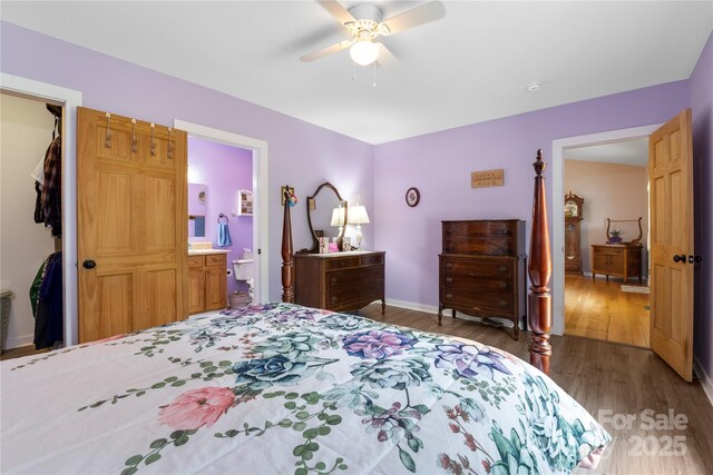 251 Vera Ln, Columbus, NC 28722 - bedroom with wood finished floors, baseboards, ceiling fan, and connected bathroom