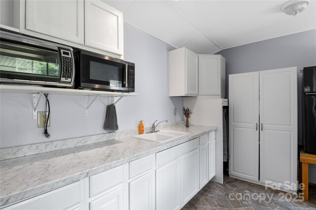 251 Vera Ln, Columbus, NC 28722 - kitchen featuring a sink, lofted ceiling, white cabinets, and dark stone finish flooring