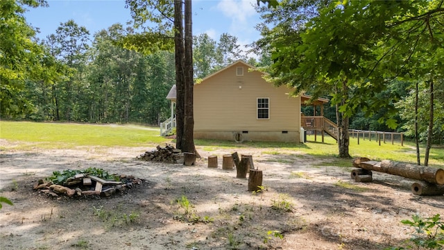 251 Vera Ln, Columbus, NC 28722 - view of home's exterior with crawl space, stairway, a lawn, and an outdoor fire pit