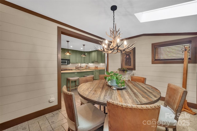 55 Toxaway Shrs Unit 14, Lake Toxaway, NC 28747 - dining room with a chandelier, a skylight, wood walls, and vaulted ceiling