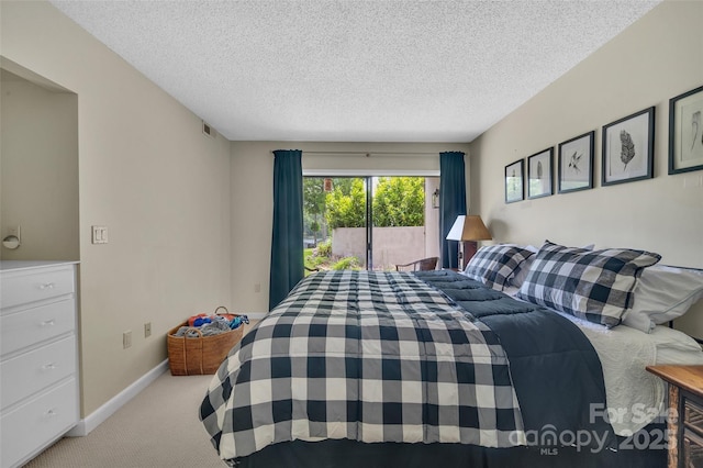 55 Toxaway Shrs Unit 14, Lake Toxaway, NC 28747 - bedroom with carpet floors, access to outside, and a textured ceiling